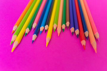 Much colour pencils on the bright pink background.