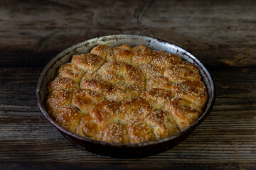 Homemade baked bread on rustic wooden background