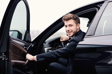 Young businessman driving alone in his luxury car