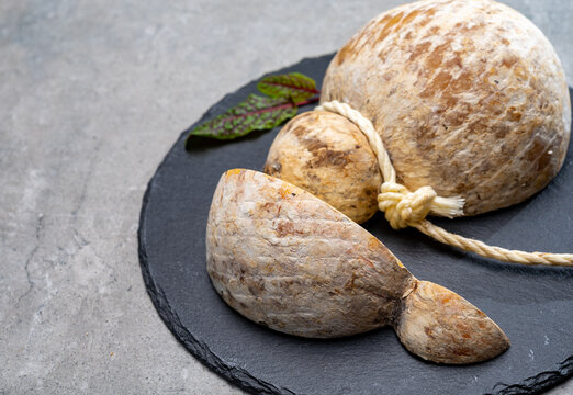 Italian semi hard matured caciocavallo cheese, handmade and aged in natural underground caves in Apulia region