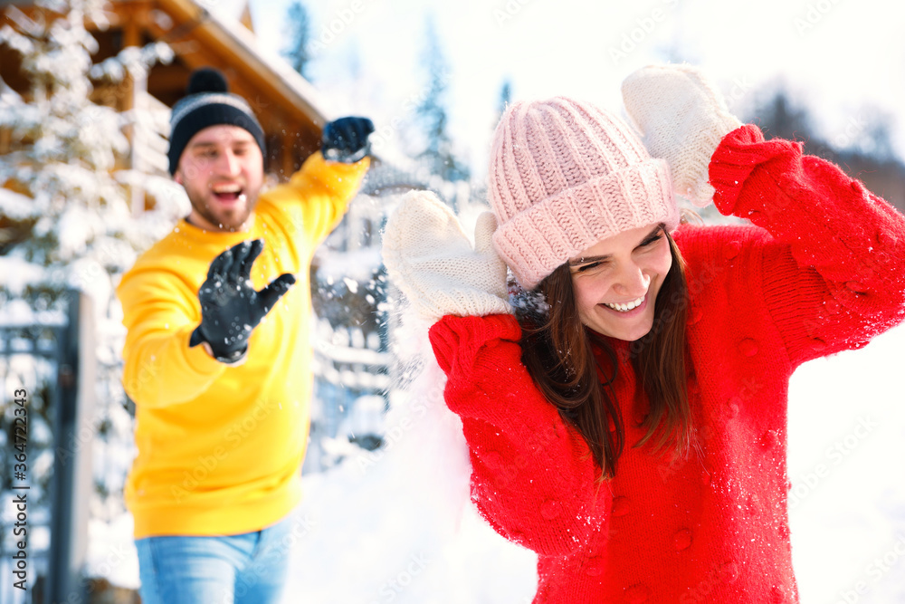 Canvas Prints Happy couple playing snowballs outdoors. Winter vacation