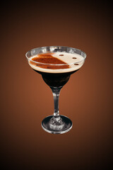 Espresso martini cocktail isolated on brown gradient