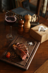 Tasty roasted meat served on wooden table in restaurant. Cooking food
