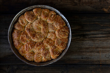 Homemade baked bread on rustic wooden background