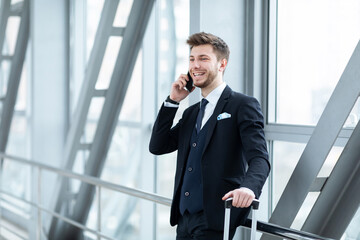 Urban business man talking on smart phone in airport