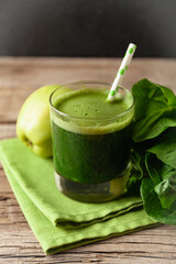 Healthy green smoothie on vintage wooden table. Fresh detox nutrient.