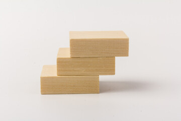 stairs concept; toy wood blocks make a stairs isolated on white background with copy space for your text