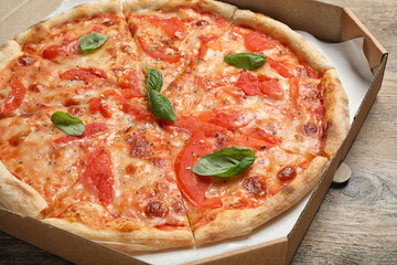 Delicious pizza Margherita on wooden table, closeup view