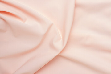 Silk pink fabric with a large fold and draped waves