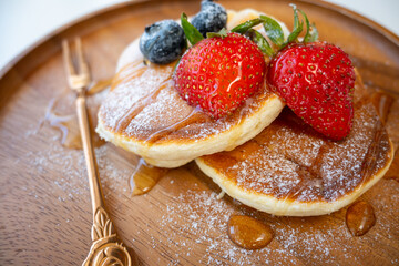 Honey pancake with strawberry and blueberry on top