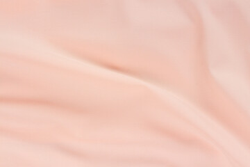 Silk pink fabric waves background full frame texture