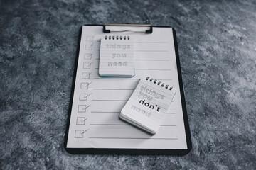 minimalism or introspection concept, notepads with texts Things you need and Things you dont need next to To Do list
