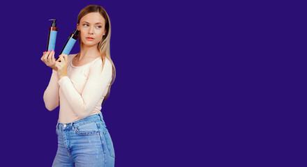 Attractive young caucasian woman presenting cosmetic products bottles