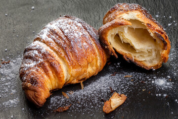 French croissant Freshly baked croissants with jam on a dark stone background. Tasty croissants with copy space