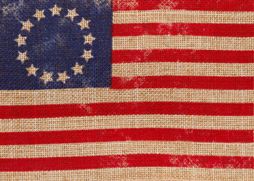 Old vintage Betsy Ross American flag on burlap background