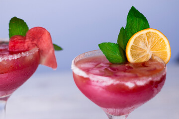 Cocktail drink details close up image. Summer cocktail smoothie in cocktail glass with mint and lemon. Holiday drink relax concept