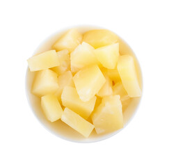 Pieces of delicious canned pineapple in bowl on white background, top view