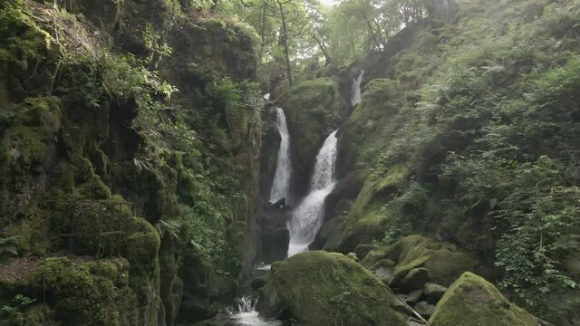4K UHD drone footage of Stock Ghyll Force waterfall at Ambleside in the Lake District, Cumbria, England, UK