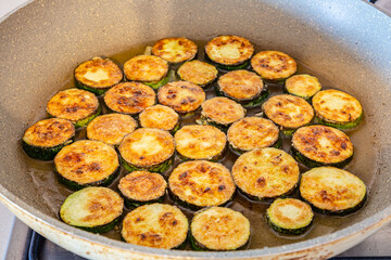 Sliced ​​zucchini fried in a pan. Food photography