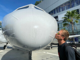 A man near a white plane. Blue sky. Journeys.