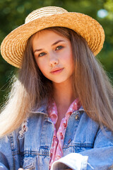 Portrait of a young model in a straw hat