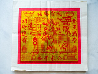 Gold Chinese joss paper which is used for ancestral worship or prayer