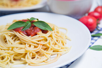 Spaghetti pasta with and tomato sauce on wood background
