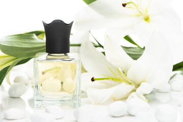 home perfume in bottle near spa stones and lilies on white background
