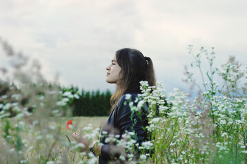 Alternative lifestyle of a woman on the meadow.