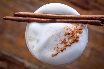 Top view of cappuccino coffee topping with cinnamon
