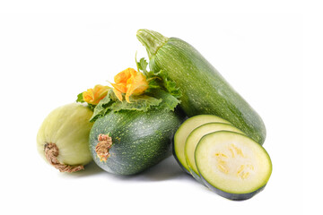three fresh zucchini with green leaves and flower isolated on a white background
