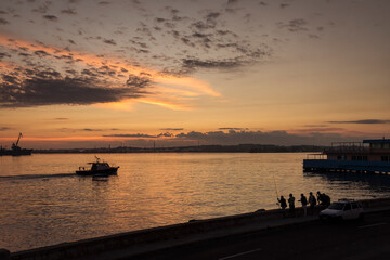 People fishing on Malecon street at sunrise in Havana, Cuba