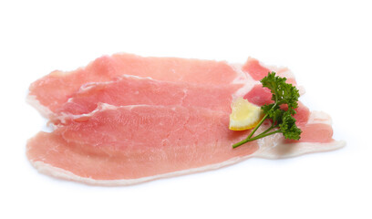 Raw pork meat with parsley herb leaves isolated on white background