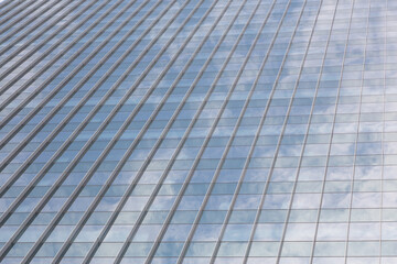 Abstract architecture of a modern building. Clouds reflected in windows of modern office building