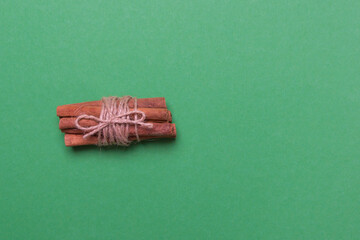 cinnamon sticks on black colored paper background with copy space, top view