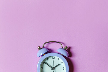 Simply minimal design ringing twin bell vintage classic alarm clock Isolated on purple violet...