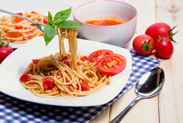 Spaghetti pasta with and tomato sauce on wood background
