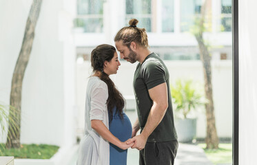 Fototapeta premium Handsome beard man take care his pregnant wife. Happy family concept.