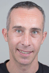 Portrait of happy mature handsome man looking at camera