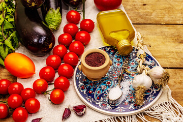 A set of products for the preparation of a traditional Turkish dish Imam Bayildi on old wooden table