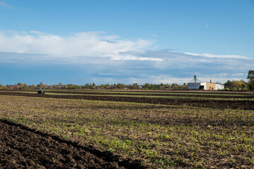Fototapeta na wymiar Tractor plowing fields - preparing land for sowing.