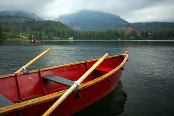 Boat with oars in the middle of a mountain lake close up.