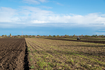 Tractor plowing fields - preparing land for sowing.