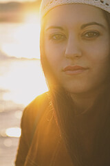 young woman with sun reflections behind