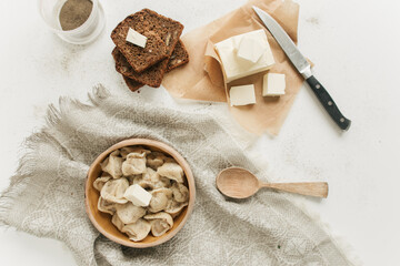Fototapeta na wymiar dumplings with butter and slices of bread