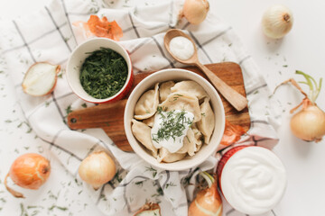 dumplings with potatoes and onions with sour cream and herbs
