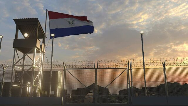 Waving flag of Paraguay above military base in the evening