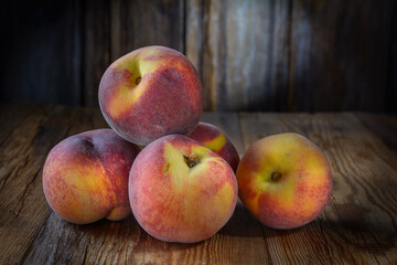 ripe peaches close-up on a dark wooden rustic background, horizontal view