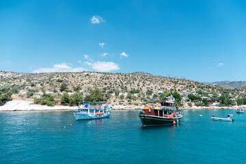 Fototapeta na wymiar Beautiful bay in Greece with traditional boats. Touristic boat tour