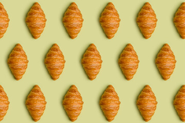 Pattern from croissants at minimal light green background
